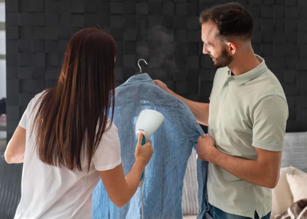 man-helping-his-wife-iron-shirt